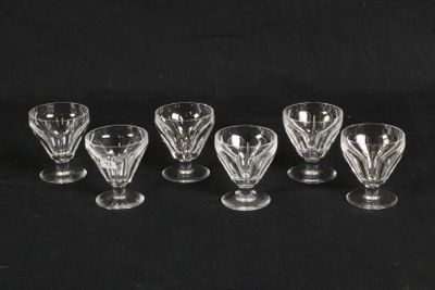 a set of six glass goblets on a black background