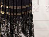 a black and gold dress on a mannequin mannequin mannequin mannequin mannequin mannequin mannequin mannequin mann