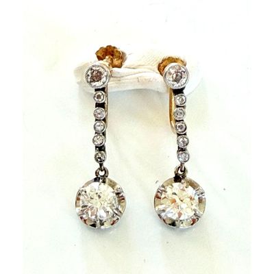 pair of diamond and gold earrings on a white background