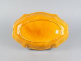 an orange bowl sitting on top of a metal stand