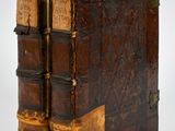 an old book with two books on top of each other