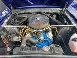 une voiture bleue dont le moteur se trouve dans le coffre