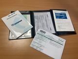 a lot of papers and a folder on a table