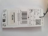 a white tag with a barcode on it on a table