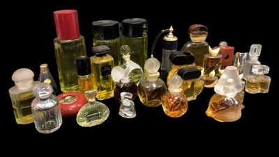many different bottles of perfume on a black background