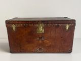 a wooden trunk with brass hardware on it