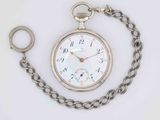 a silver pocket watch with a chain around it