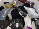a pile of clothes and other items in a plastic bag