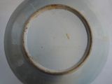 a white plate with a brown rim sitting on a table