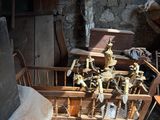 a man standing in front of a pile of old furniture