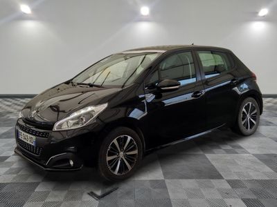 the black car is parked in the garage on a checkered floor