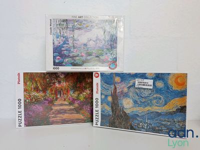 three cards with paintings on them sitting on a white surface