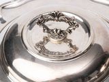 a silver plate with a decorative design on it