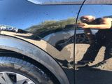 a reflection of a man in the side mirror of a car