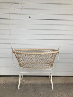 a white basket that is sitting on the ground