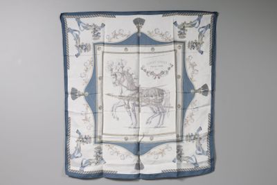 a blue and white scarf with a picture of a horse drawn carriage