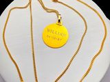 gold plated necklace with a gold chain and a gold pendant with the words wild west on it