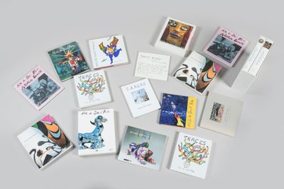 many cards laid out on a table with a cup of coffee
