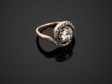 a gold and diamond ring on a black surface