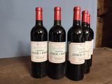 three bottles of wine sitting on top of a wooden table