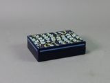 a small black box with a flower pattern on it