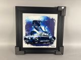 a framed picture of a car with a dinosaur in the background