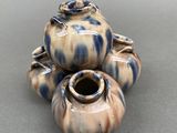 three vases sitting on top of each other on a table
