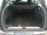 the back of a car with its trunk open and the back seats down