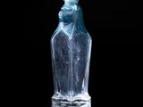 a clear glass bottle with a bird on top of it