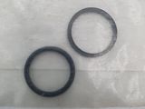 two black rubber o - rings on a white surface