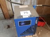 a blue machine that is sitting in a garage
