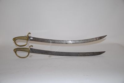 pair of two swords on a white surface with a pair of scissors in the foreground
