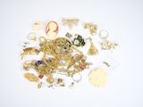 a pile of gold and silver jewelry on a white surface