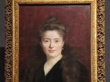 portrait of a woman in a fur coat by an easel