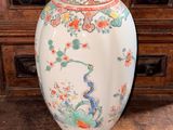 a large vase sitting on top of a wooden table