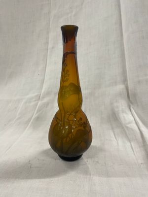 un vase marron orné d'un motif sur fond blanc