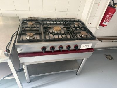 a gas stove with a fire extinguisor on top of it