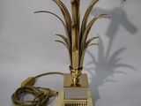 brass plated table lamp with a glass shade and a gold metal base