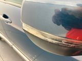 a reflection of a person in the side mirror of a car