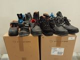several pairs of shoes are stacked on top of boxes in a room