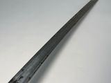 a close up of a knife on a white surface