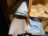 a shelf with folded towels and folded towels on it