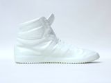 white high top sneakers on a white surface with a white background
