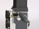 a black and white photo of a camera on a white surface