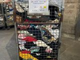 a metal cart with many items in it in a warehouse