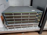 a close up of a rack with a bunch of switches on top of it