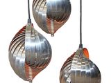three metal pendant lights hanging from a wire on a white background