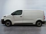 the white van is parked on the concrete floor in the room