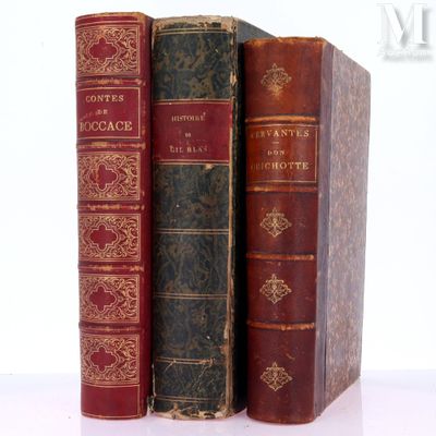 three old books sitting on top of each other on a table
