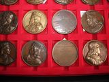 a red box filled with a lot of silver coins